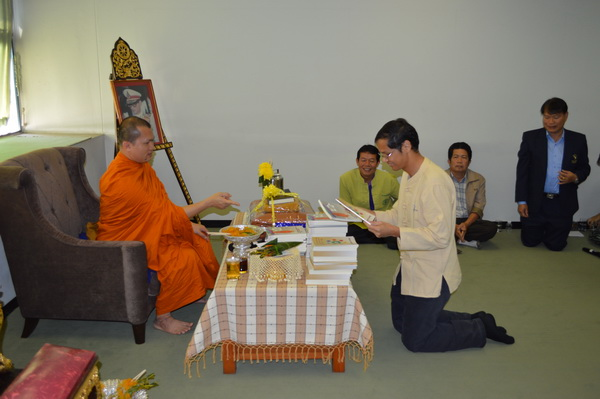 The library staffs celebrates New Year 2014 by making merit in Buddhism.